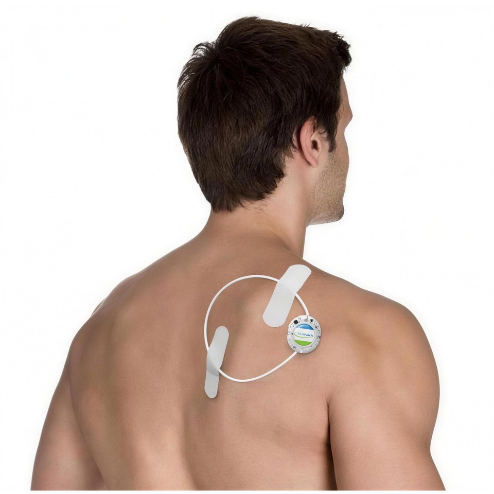 Muscular white man viewed from behind with an ActiPatch® loop and control unit secured to his upper back with two white tape strips